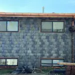 Modern house with slate tile siding and copper gutters.