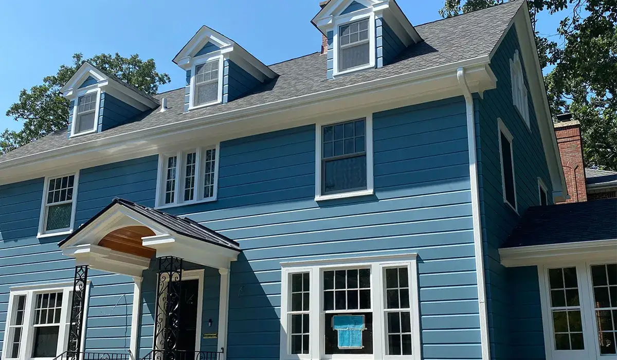 Blue clapboard home with a gray architectural asphalt shingle roof, the most affordable option