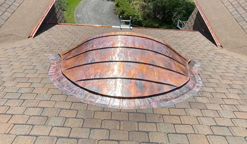 Asphalt shingle roof with custom copper metalwork, showing both roofing materials on one Illinois home