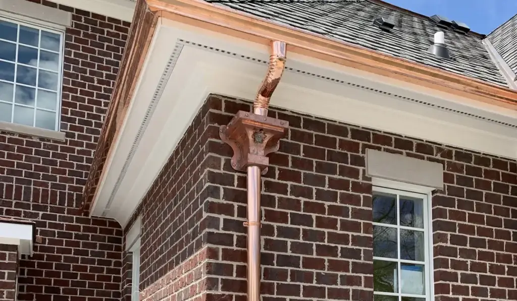 Brick home with newly installed copper gutters and roofing