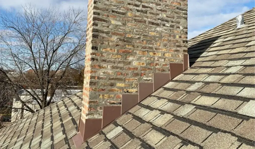 Stone chimney and slate roof — flashing is a common source of roof leaks