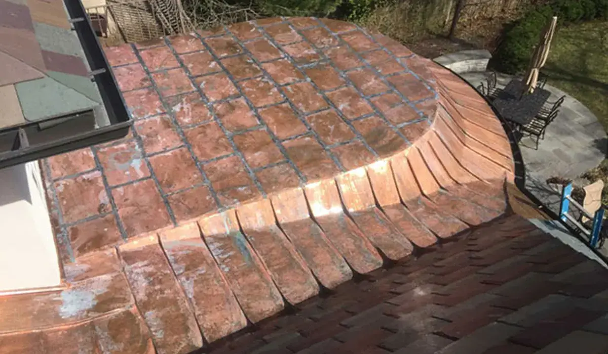 Curved low-slope copper roof with flat-lock seam panels, the system used on bay window roofs