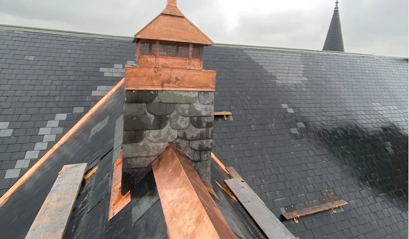 Slate roof with a copper spire that can last 75 to 100 years, far longer than asphalt
