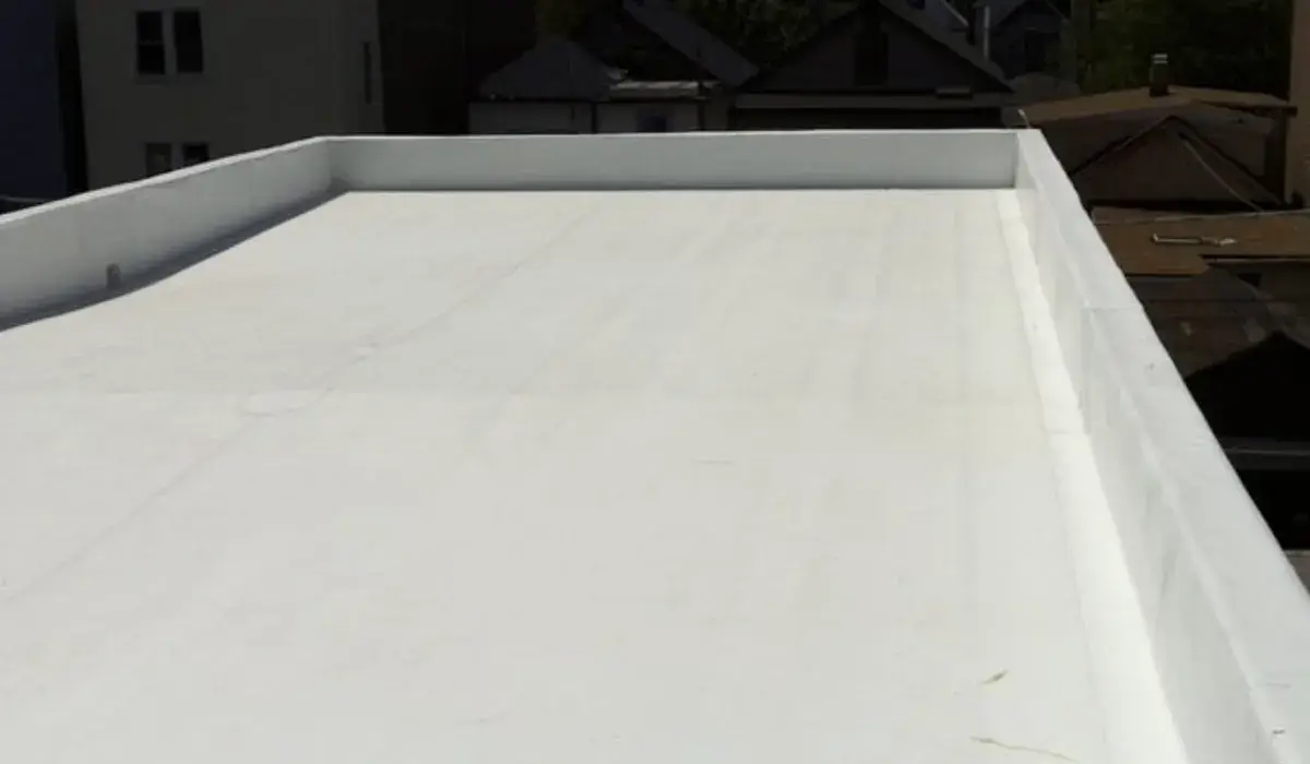 Close-up of a white TPO membrane field, the surface that crazes and chalks as its UV package wears out
