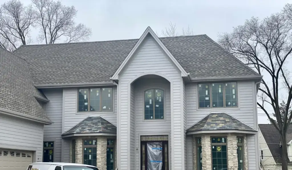 Black Square Roofing service van at an Arlington Heights home during the cold season, when winter roof work happens