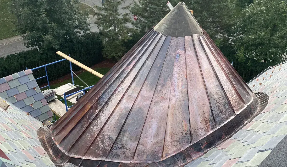 Copper conical turret roof formed in flat-lock panels, the system used on curved and low-slope surfaces